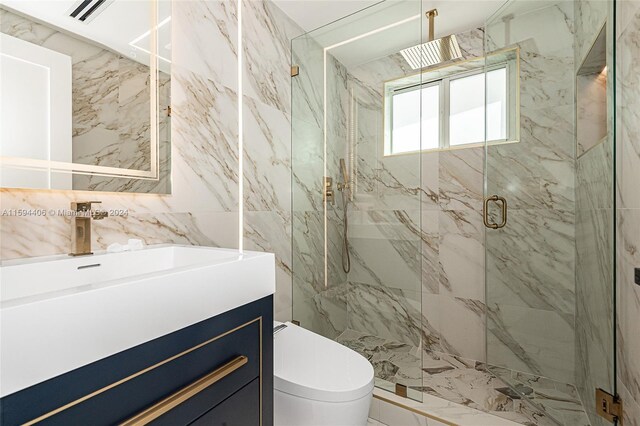 bathroom featuring an enclosed shower, vanity, toilet, and tile walls