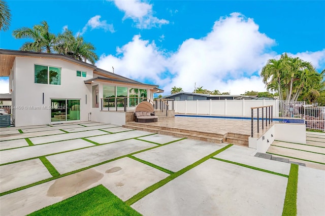 rear view of house featuring an empty pool and a patio area