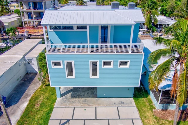 rear view of house with a balcony and central AC