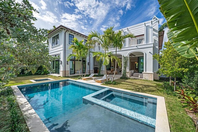 view of front of house featuring a balcony and a front lawn