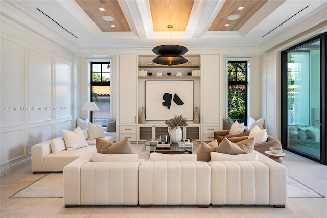 living room featuring beam ceiling, crown molding, and a wealth of natural light