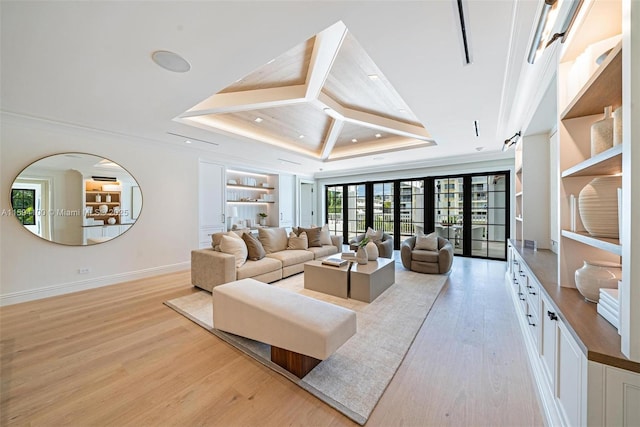 living room featuring a tray ceiling, recessed lighting, light wood-style flooring, and baseboards