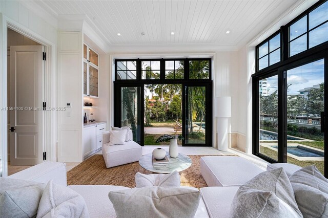 kitchen featuring premium range hood, pendant lighting, sink, white cabinets, and backsplash