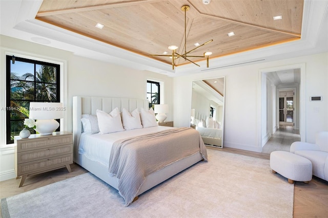 bedroom featuring baseboards, a raised ceiling, wood ceiling, and an inviting chandelier