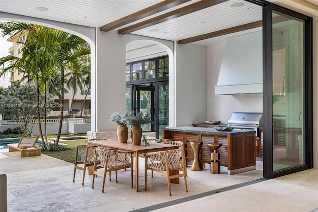 dining area featuring beamed ceiling