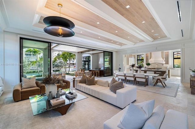 living room featuring ornamental molding, a raised ceiling, beam ceiling, and recessed lighting