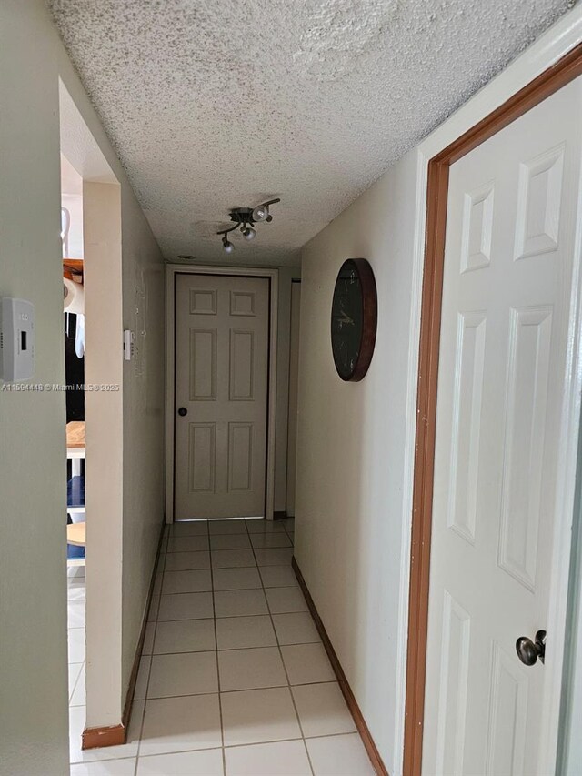 6921 Environ Blvd Unit 4N, Lauderhill, FL 33319 - hallway featuring light tile patterned floors and a textured ceiling