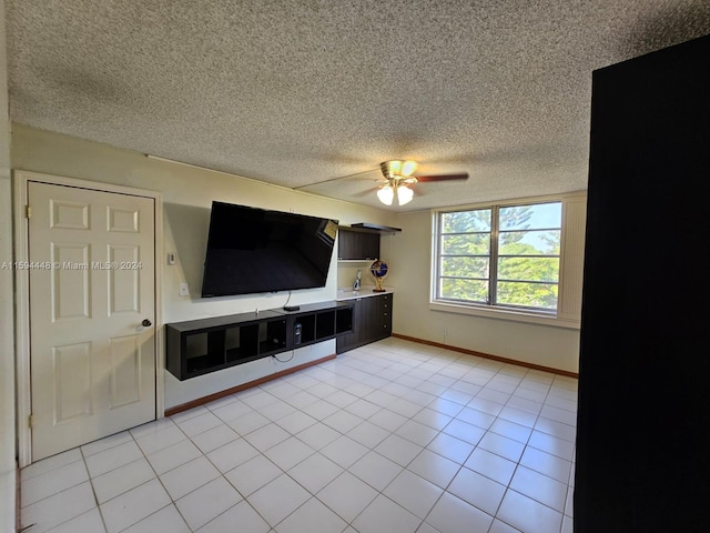 unfurnished living room featuring a textured ceiling, light tile patterned floors, and ceiling fan