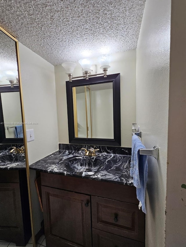 bathroom with vanity and a textured ceiling