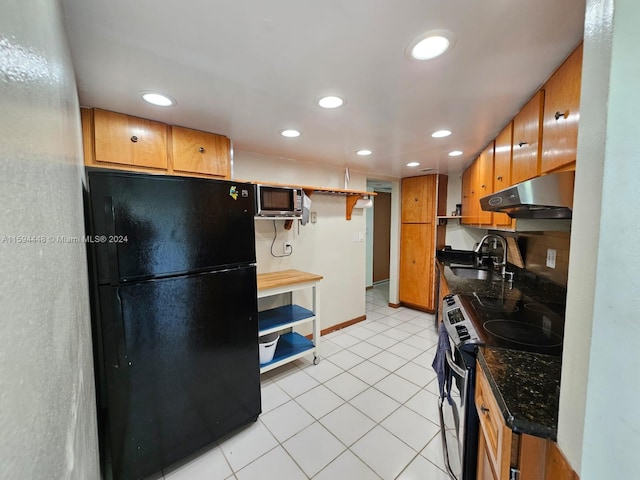 kitchen with appliances with stainless steel finishes, light tile patterned floors, and sink