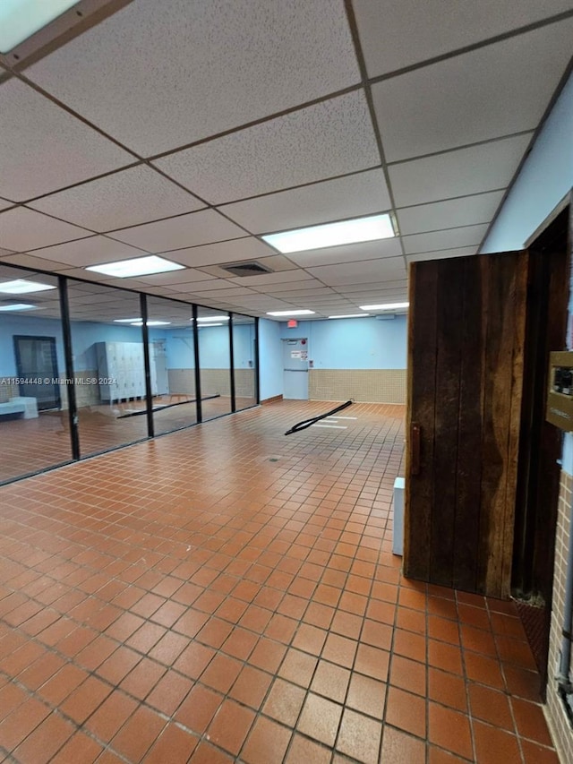 interior space featuring a paneled ceiling and visible vents