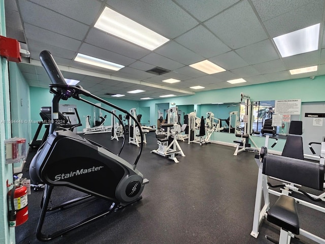 exercise room with a paneled ceiling