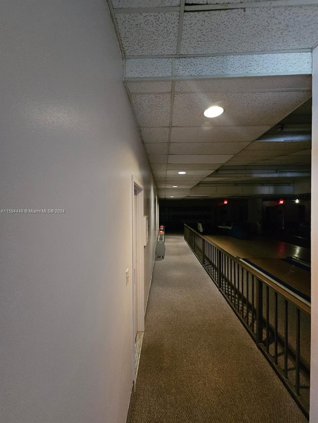 hallway with recessed lighting, carpet flooring, and a paneled ceiling