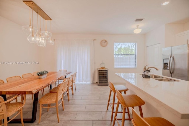 dining room featuring sink and light tile floors