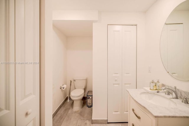 bathroom featuring toilet and vanity