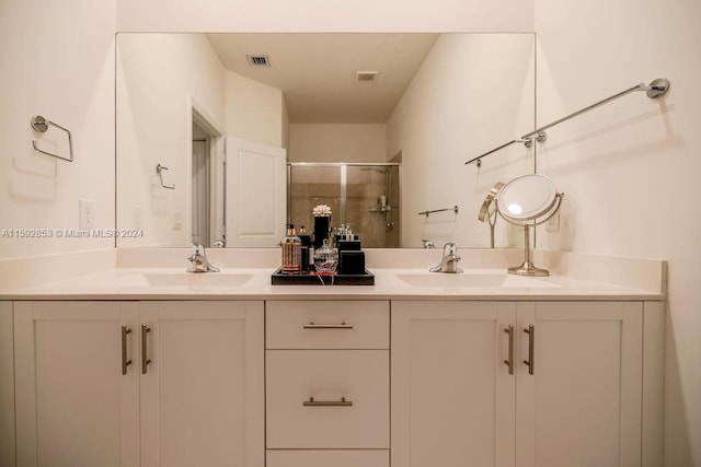 bathroom featuring an enclosed shower and double sink vanity