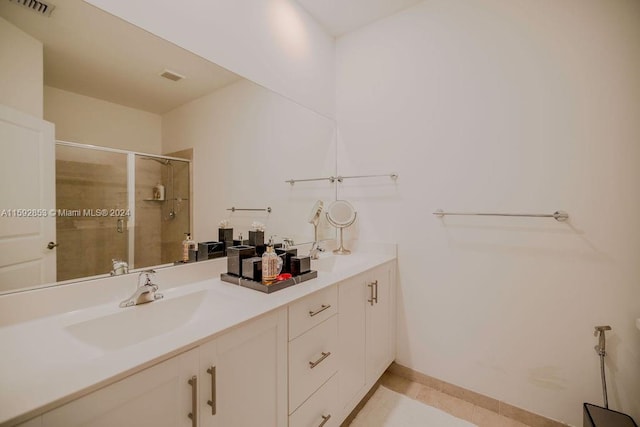 bathroom with a shower with shower door, tile flooring, and double vanity