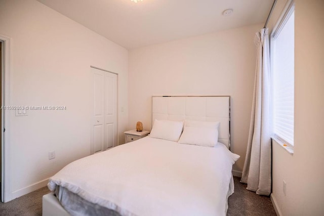 carpeted bedroom with a closet