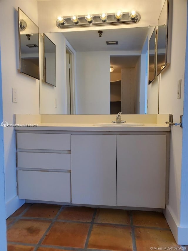 bathroom with tile floors and large vanity