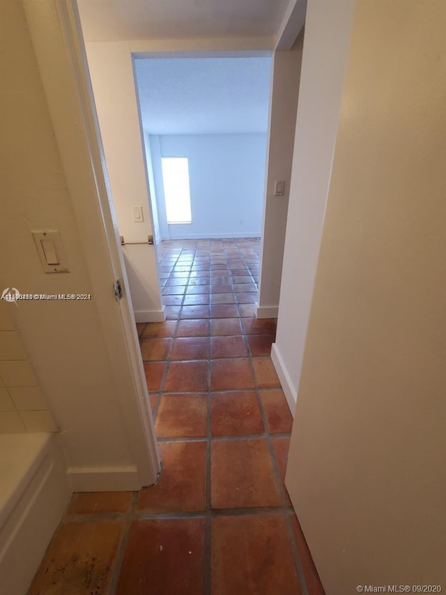 hallway with tile floors