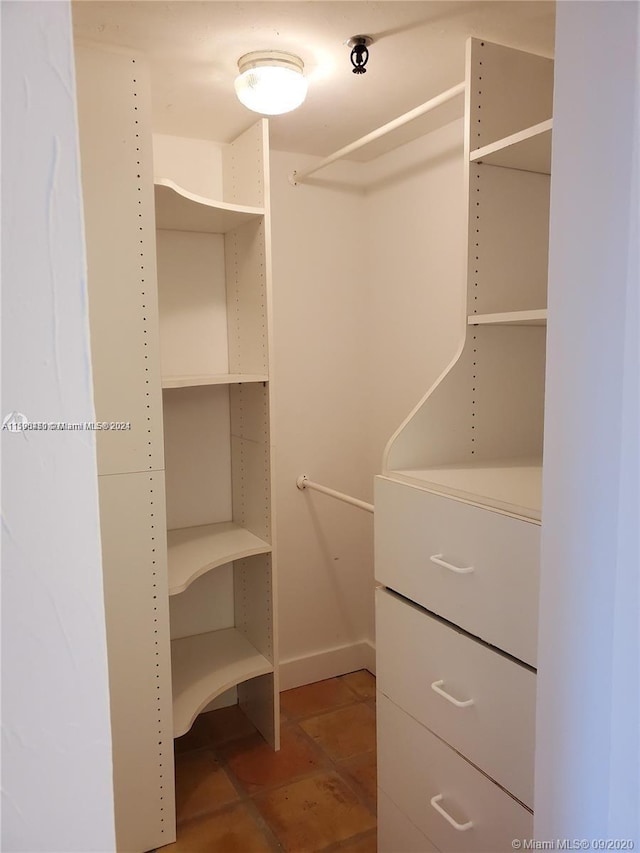 spacious closet featuring tile floors