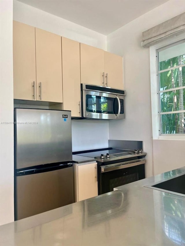 kitchen with cream cabinets and stainless steel appliances