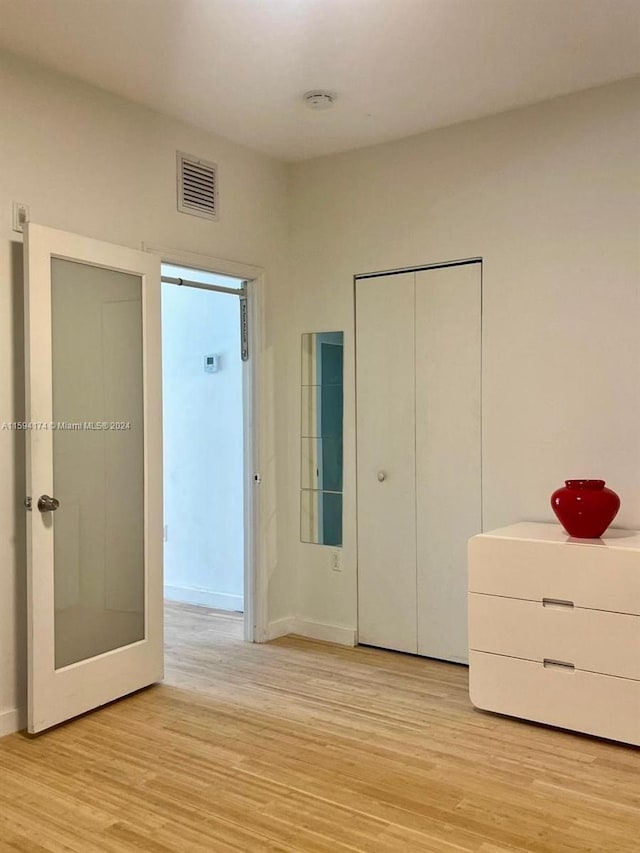 unfurnished bedroom featuring light wood-type flooring