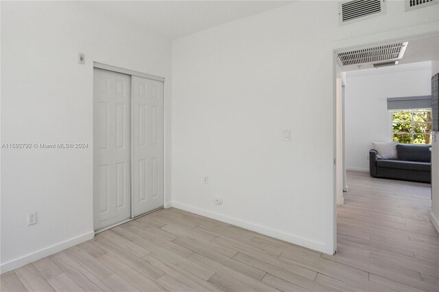 empty room with light hardwood / wood-style floors