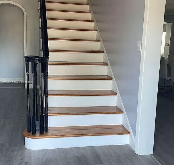 stairway with hardwood / wood-style flooring