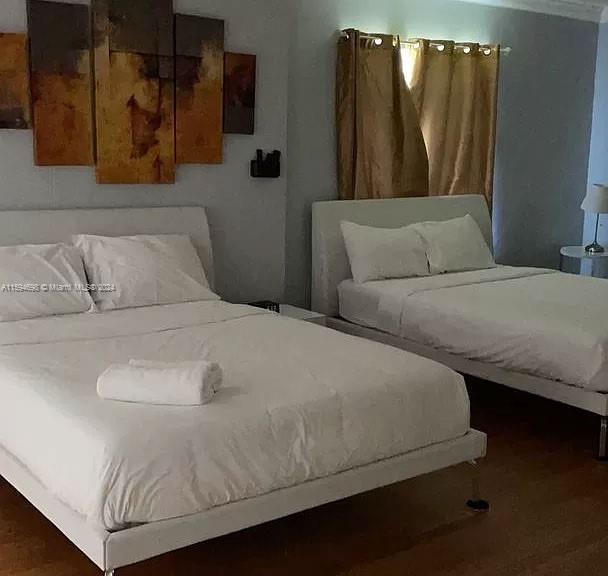 bedroom with dark wood-type flooring