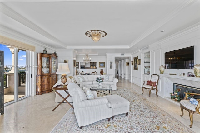 tiled living room featuring a notable chandelier, ornamental molding, a tray ceiling, and a fireplace