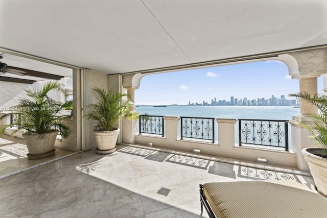 interior space featuring ceiling fan and a water view