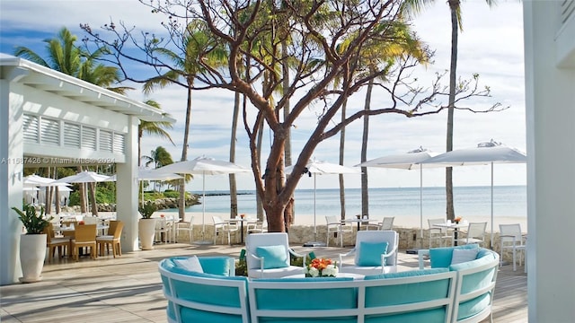 wooden terrace with a patio and a water view