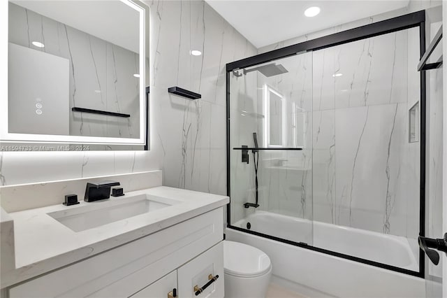 full bathroom with shower / bath combination with glass door, vanity, and toilet