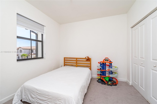 carpeted bedroom featuring a closet