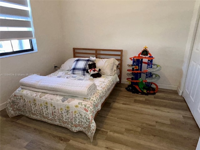 bedroom with hardwood / wood-style floors