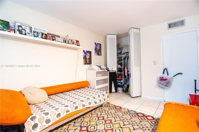 bedroom featuring light tile patterned floors and a closet