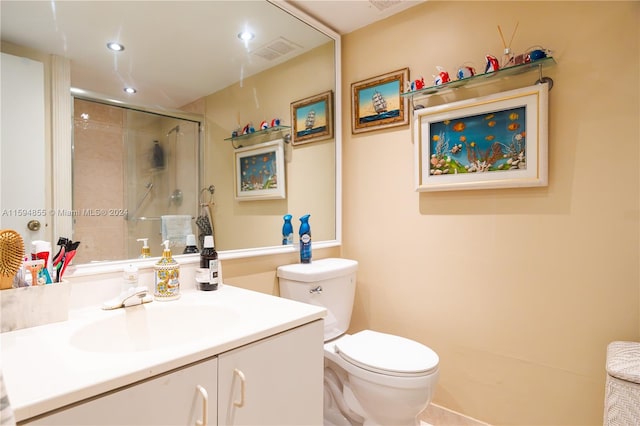 bathroom with vanity, toilet, and a shower with shower door