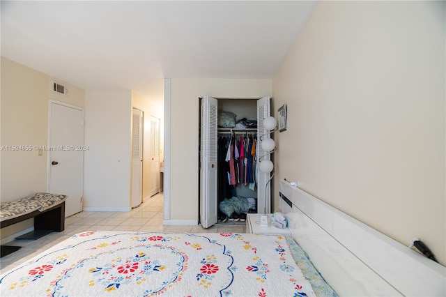 tiled bedroom featuring a closet