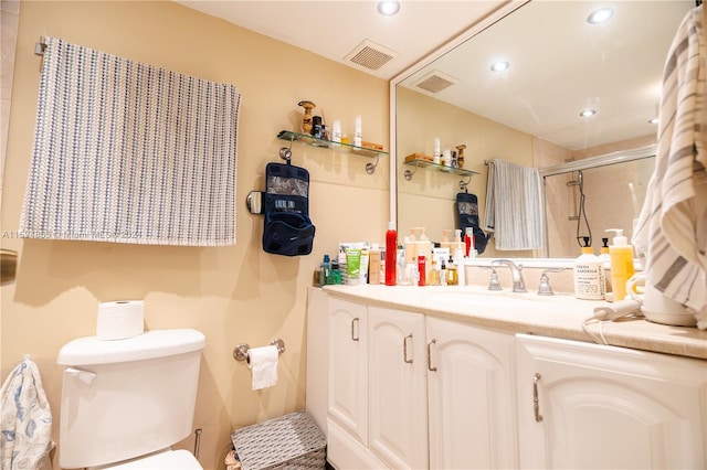 bathroom featuring vanity, toilet, and a shower with door