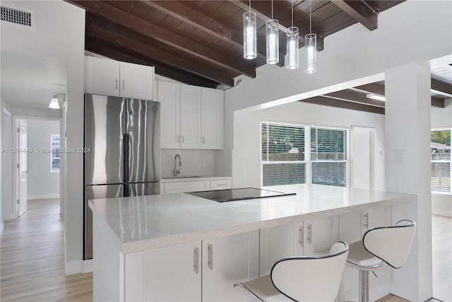 kitchen featuring tasteful backsplash, vaulted ceiling with beams, white cabinets, light hardwood / wood-style floors, and wood ceiling