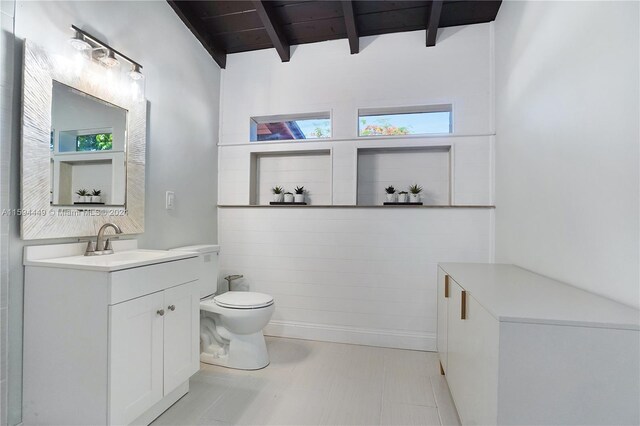 bathroom featuring tile patterned flooring, vaulted ceiling with beams, toilet, vanity, and wooden ceiling