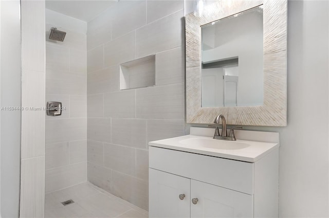 bathroom featuring vanity and tiled shower