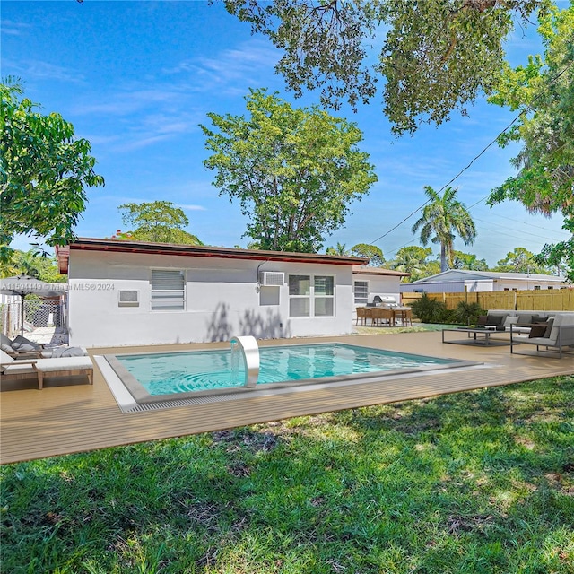 view of pool featuring an outdoor living space, a patio area, and a lawn