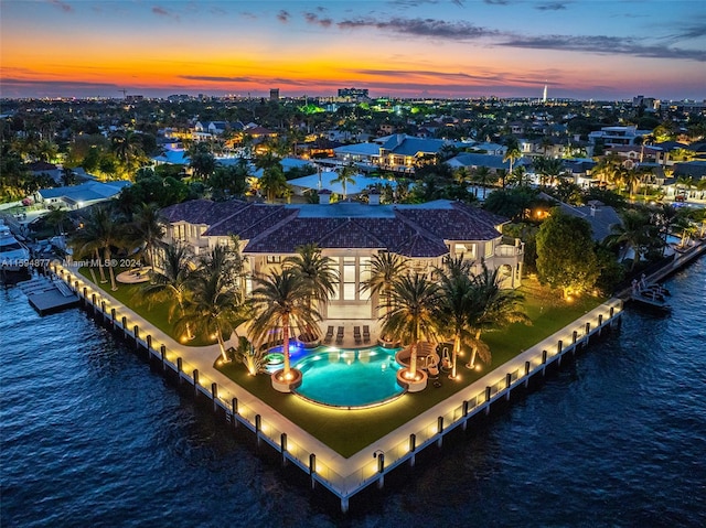 aerial view at dusk with a water view