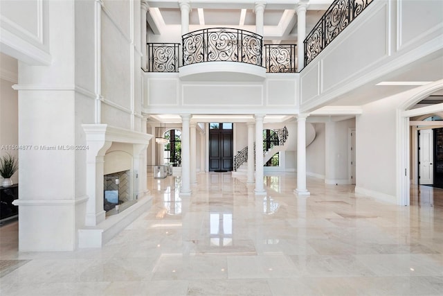 entrance foyer with a high ceiling and decorative columns