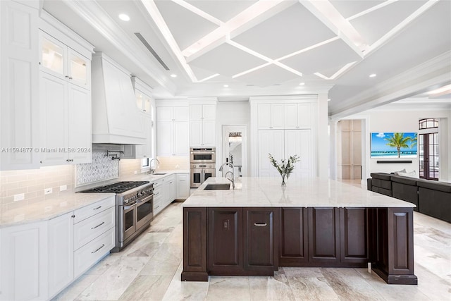 kitchen featuring a large island, white cabinetry, stainless steel appliances, and custom range hood