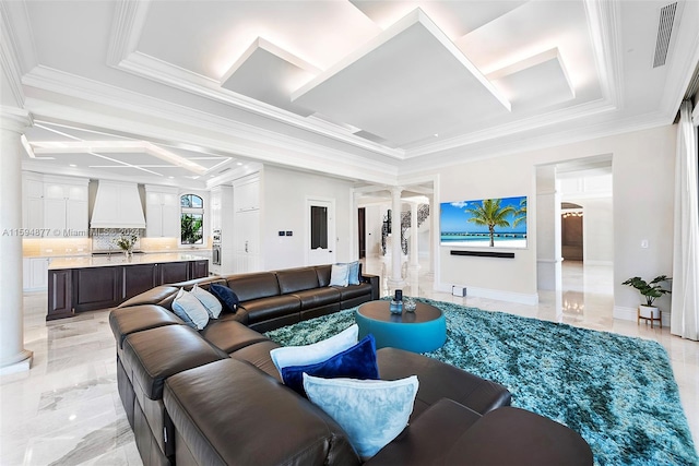 living room with decorative columns and ornamental molding