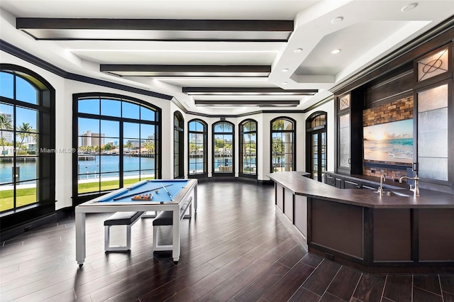 game room with a water view, pool table, dark wood-type flooring, and sink