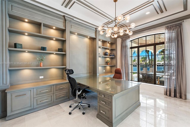 office area with built in features, ornamental molding, and an inviting chandelier